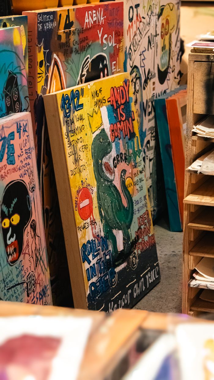 Vibrant collection of abstract street art paintings in a Barcelona studio, showcasing urban creativity.